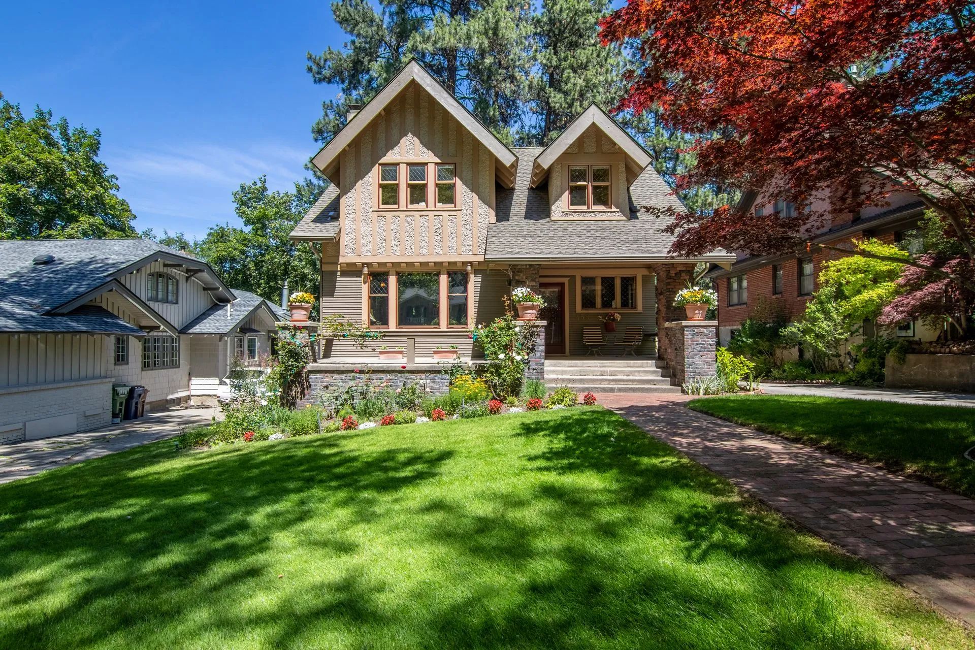 A freshly mowed green lawn in front of a New England home